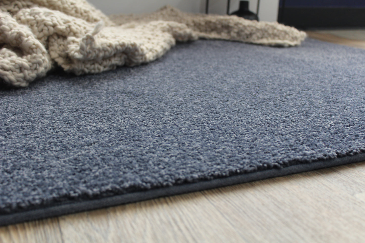 Country Denim Blue Area Rug sideview with blanket