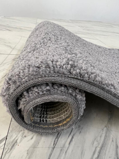 Concrete Grey Area Rug rolled up